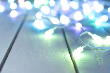 Bright lights blur into the background over a white vintage style wooden table