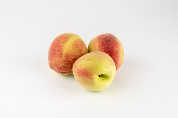 Group of peaches over white background.