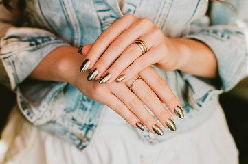 Stylish trendy female mirror manicure, metal nail art