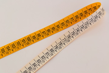 Tailor measuring tapes. Yellow and white sides with numbers showed in centimeters