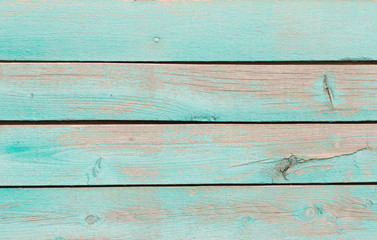 Fototapeta na wymiar wooden background, a fragment of the wall of an old wooden house painted in turquoise