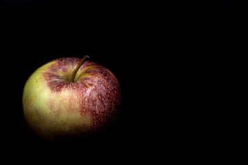 Apple red and yellow on a black background