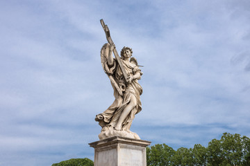 Fototapeta na wymiar Angel with the cross, sculpture by Ercole Ferrata on the Pont Sant'Angelo bridge in Rome