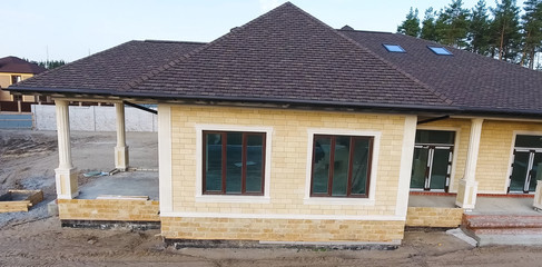 Bituminous tile for a roof. House with a roof from a bituminous tile. a roof from a bituminous tile. Moder