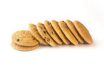 Oatmeal cookies with chocolate chips lie sideways on a white background.