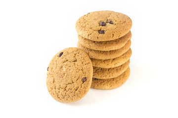 Six oatmeal cookies with chocolate topping on a white plate horizontally and one vertically.