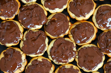 a lot of chocolate muffins, homemade sweet pastries buns or donuts