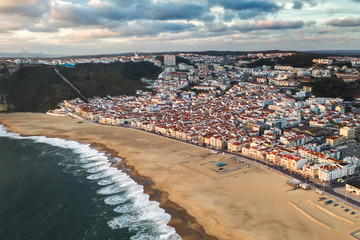 tourist resort town sea or ocean with a clean sand beach, travel Nazare Portugal europe