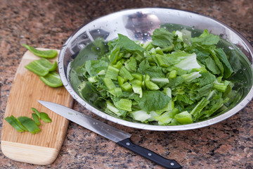 Different salad ingredients on a plate waiting to be used.