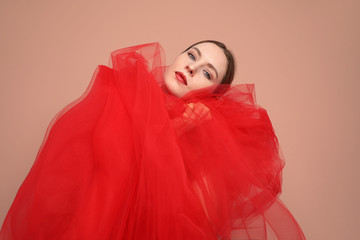 Fashion young woman posing in the studio. Close-up portrait. Colourful background.