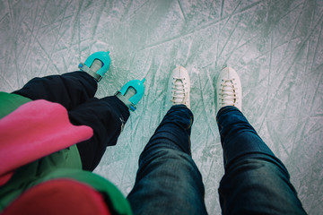 mother and child skating together in winter