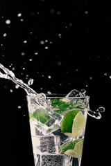 Fototapeta na wymiar Vodka lime tonic. Alcoholic cocktail and splash. Taste and refreshing cocktail concept.