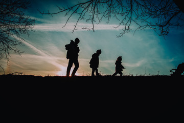 Fototapeta na wymiar father with kids walk in sunset nature, parenting