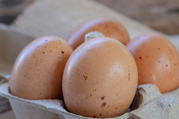 Closed up chicken eggs on paper box. Food background. High nutrition ingredient for meal.