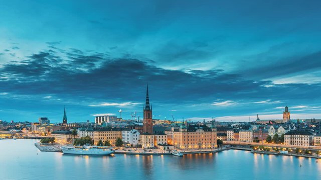 Stockholm, Sweden. Scenic View Of Stockholm Skyline At Summer Evening. Famous Popular Destination Scenic Place In Dusk Lights. Riddarholm Church In Day To Night Transition Time Lapse