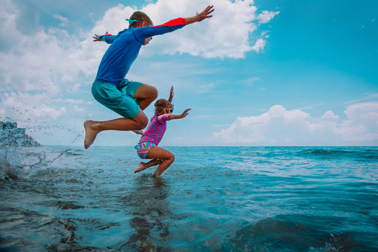 Happy Boy And Girl Run Swim On Beach