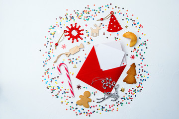 Image of red envelope, cookies, christmas decoration on white background