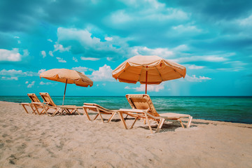 Beach chairs on tropical vacation, travel to sea concept
