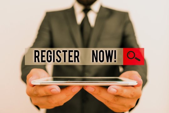 Text sign showing Register Now. Business photo text official list or record showing or things into web or forum Male human wear formal work suit hold smart hi tech smartphone use hands