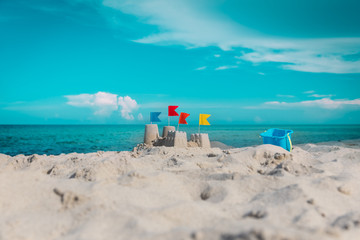 Fototapeta na wymiar Sand castle on beach vacation and toys
