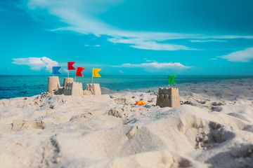 Sand castle on beach vacation and toys