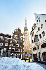 A view of the Riga old town and St. Peter's Church on a clear winter day. Snow-covered houses....
