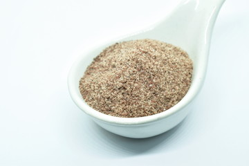 Himalayan black salt or volcanic rock salt on spoon in white background