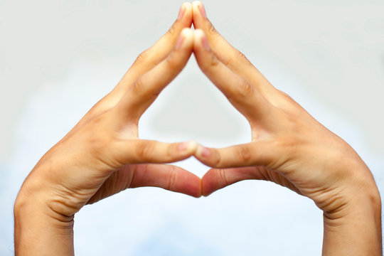 isolated hands of male teenage boy doing Hakini Yoga Mudra on a white colored background.