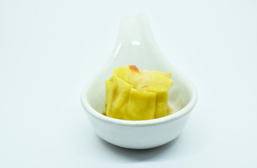 Chinese dumpling stuffed mashed shrimp and pork dressing soy sauce on spoon in white background