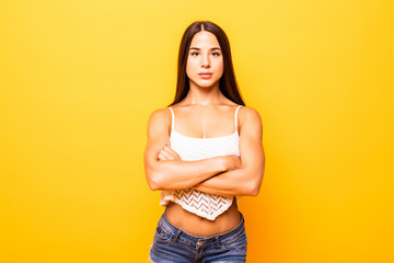 Funny young woman isolated on yellow background.