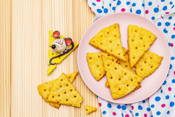Funny kids cookies. Festive cheese crackers, New Year snack concept. Food, mouse sculpture, napkin. Wooden planks background