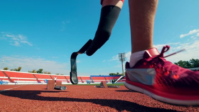 Slow motion of two disabled men start running