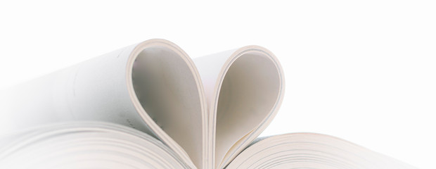  Open book with curled leaves in the shape of a heart.