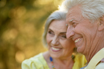 Portrait of happy senior woman and man in park