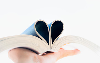  Open book with curled leaves in the shape of a heart.