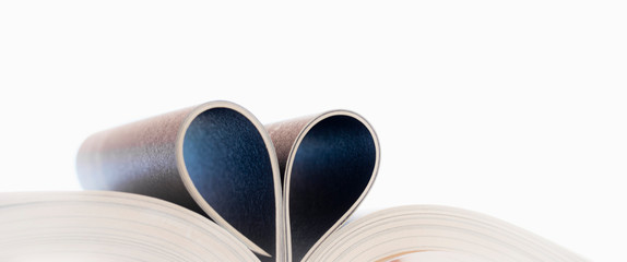  Open book with curled leaves in the shape of a heart.