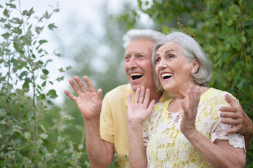 Obraz premium Portrait of happy senior woman and man in park