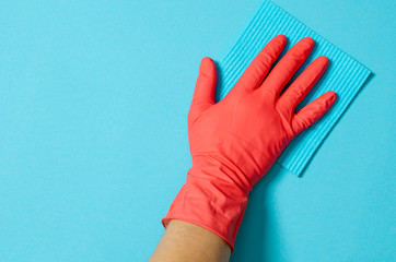 Employee hand in rubber protective glove with micro fiber cloth wiping wall from dust. Commercial...