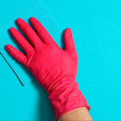 Employee hand in rubber protective glove with micro fiber cloth wiping wall from dust. Commercial cleaning company concept