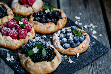 biscuit with berries of blackberry, raspberry, blueberry, black currant, strawberry