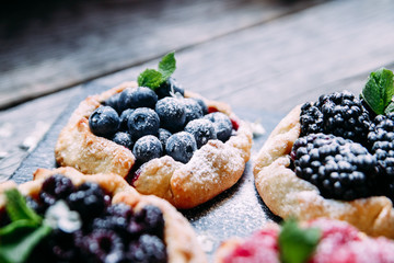 biscuit with berries of blackberry, raspberry, blueberry, black currant, strawberry
