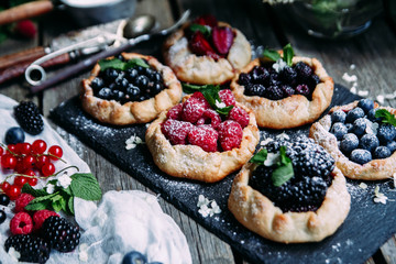 biscuit with berries of blackberry, raspberry, blueberry, black currant, strawberry