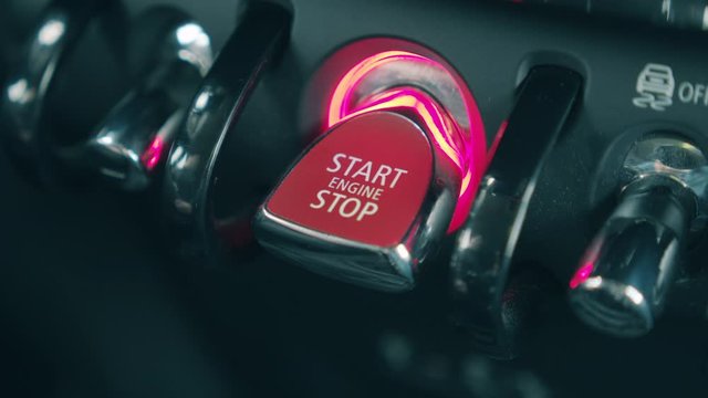 Car's engine is getting started with a button getting pressed