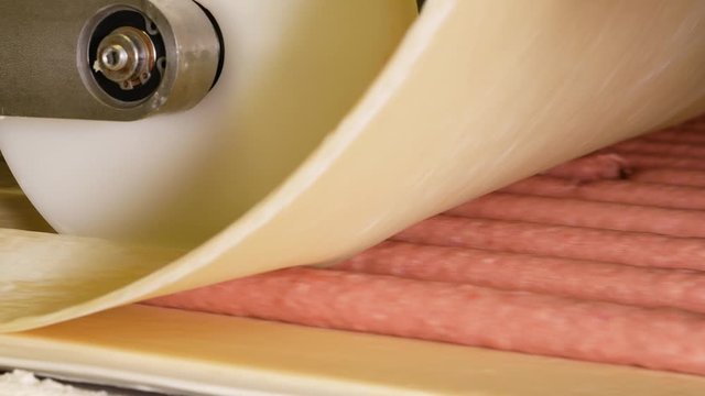 Sausages on a conveyor in a food factory
