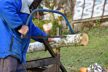 Traditional way of sawing wood in the village