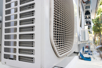 Air conditioner condenser unit standing outdoors