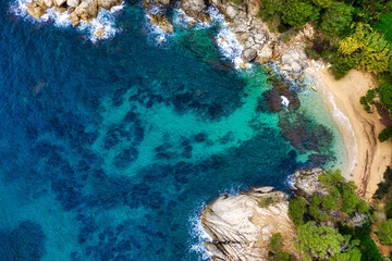 Sea Aerial view. Top view, nature background. Azure sea beach with rocky mountains and clear water at sunny day. Flying drone. Tropical trees.