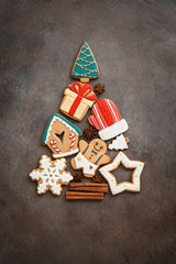Abstract Christmas tree from gingerbread. Beautiful festive background with various gingerbread cookies. Top view, flat lay, copy space.