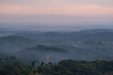 Mountain top view of local villages in northen Thailand during sunrise with fog