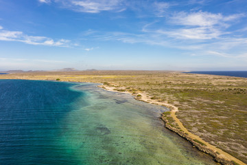 Aerial view of coast of Curaçao in the Caribbean Sea with turquoise water, cliff, beach and beautiful coral reef around Eastpoint